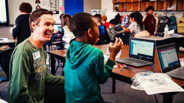 Patrick-with-youth-learning-about-circuits.jpeg