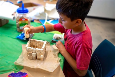 Boy-glueing-blocks.jpeg